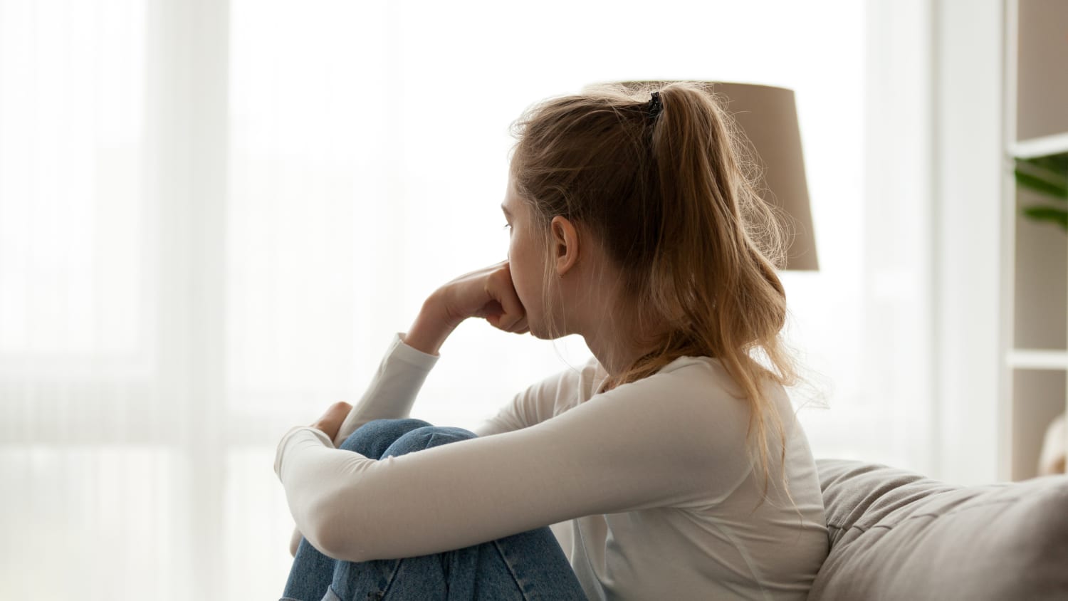 woman looking thoughtful, because of heavy menstrual bleeding