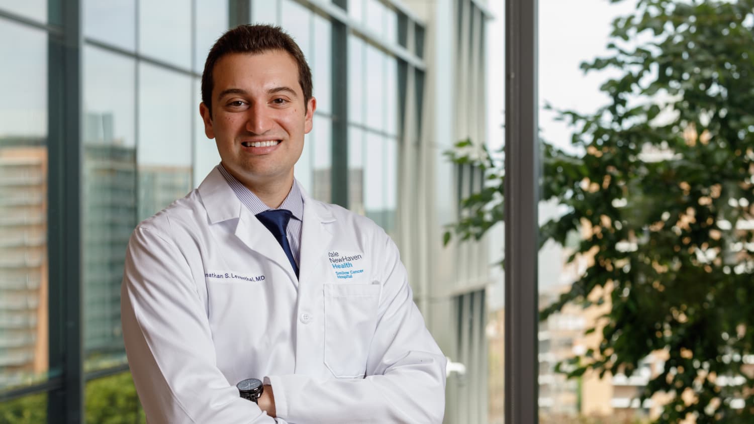 Dr. Leventhal stands in the hallway with his arms crossed.