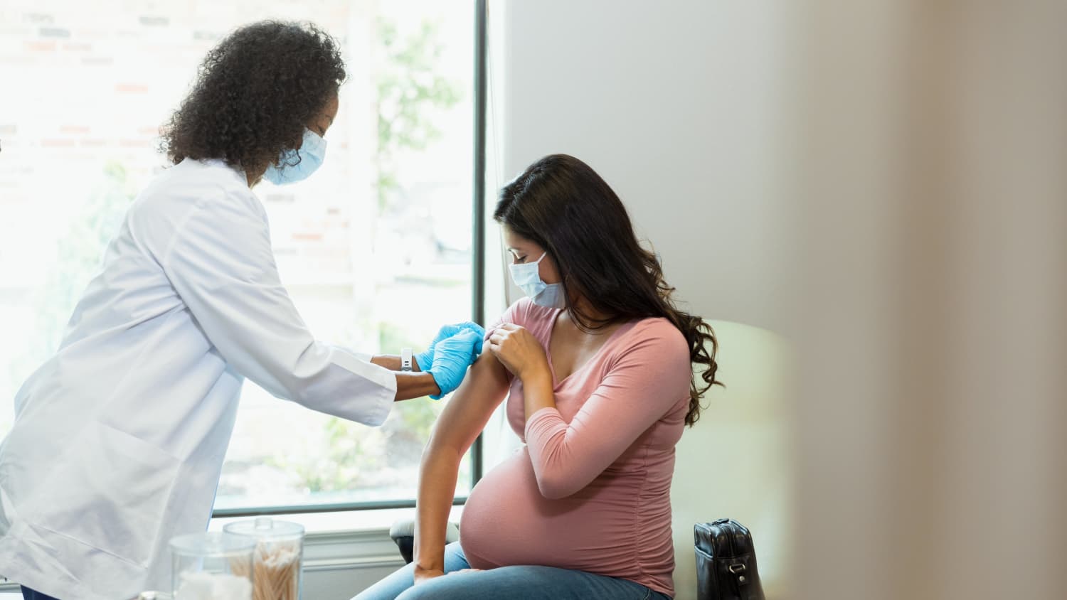 pregnant woman receiving vaccination against COVID-19