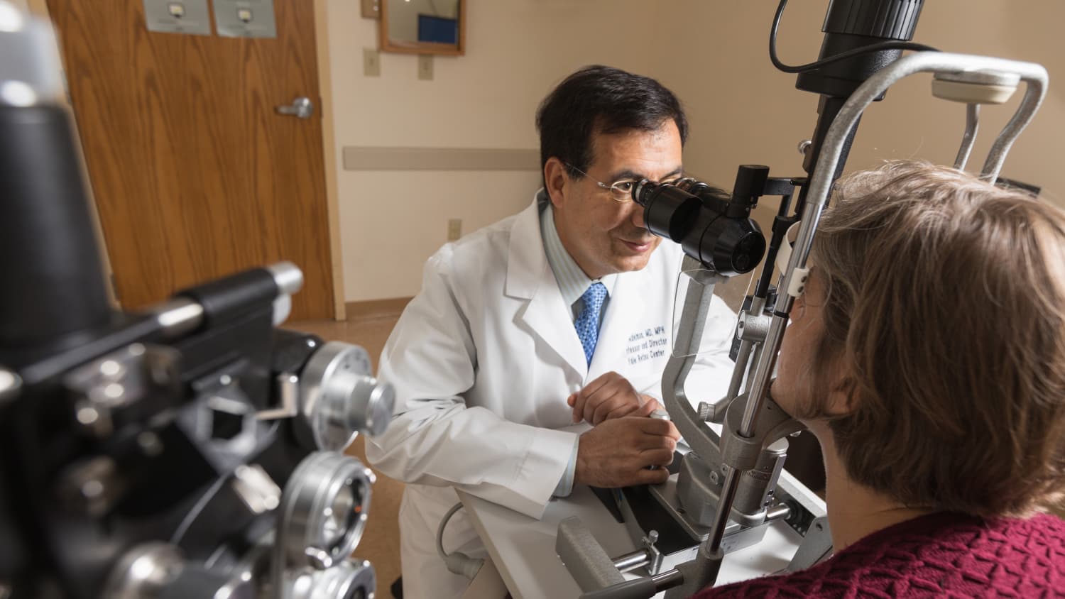 Physician giving a patient an eye exam