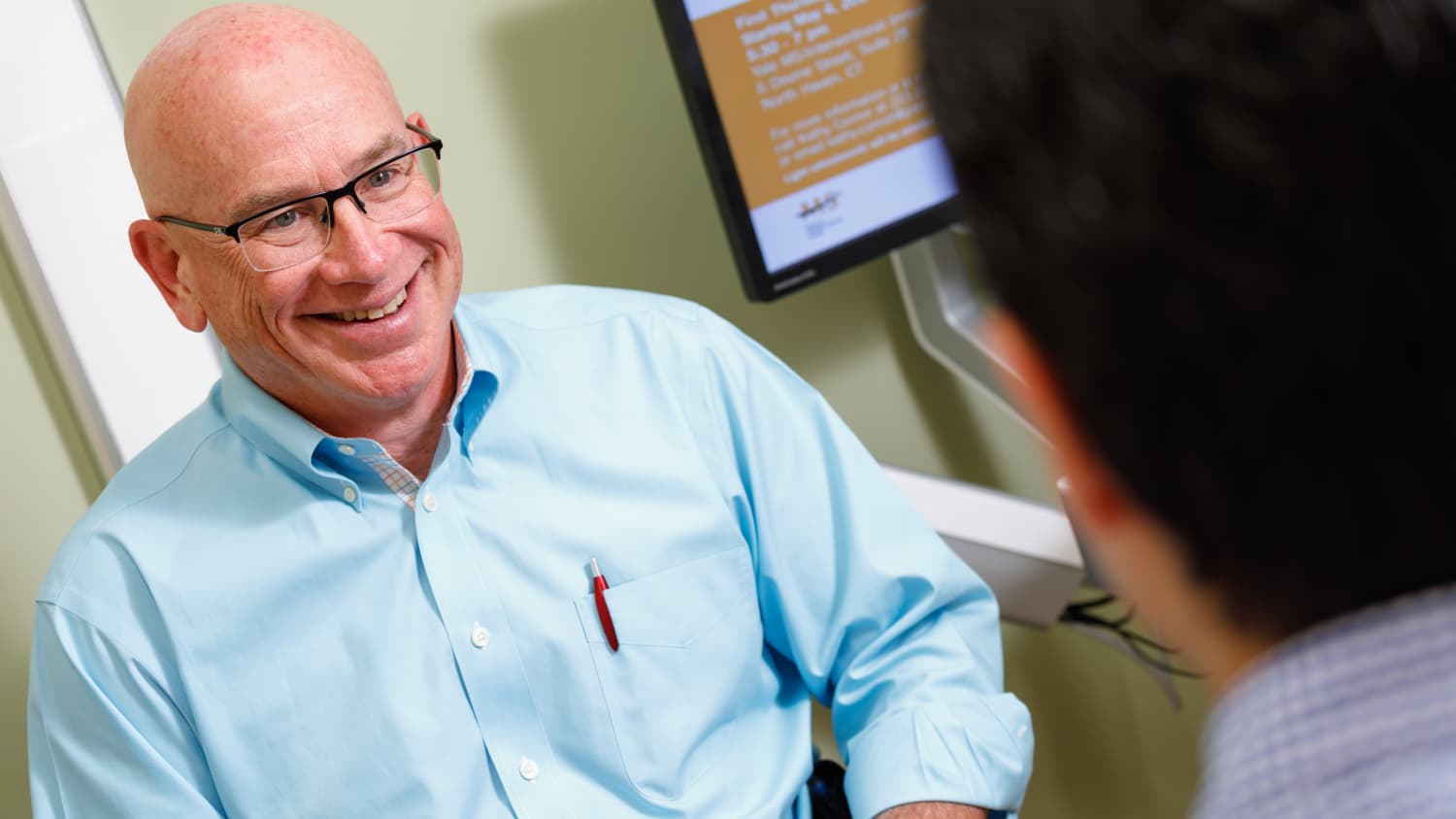 Dr. Honig talks to a patient.