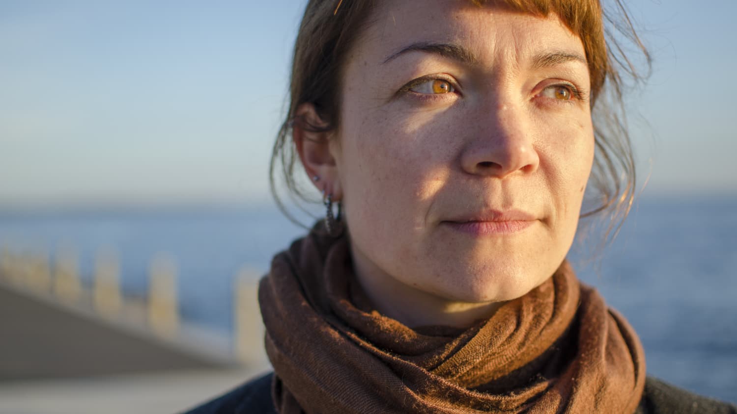 middle aged woman looking thoughtful, possibly worried about abdominal uterine bleeding