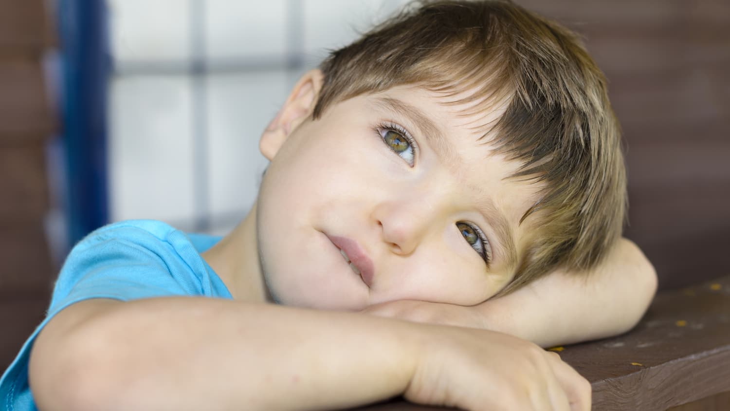 A child with a movement disorder looks off into the distance.