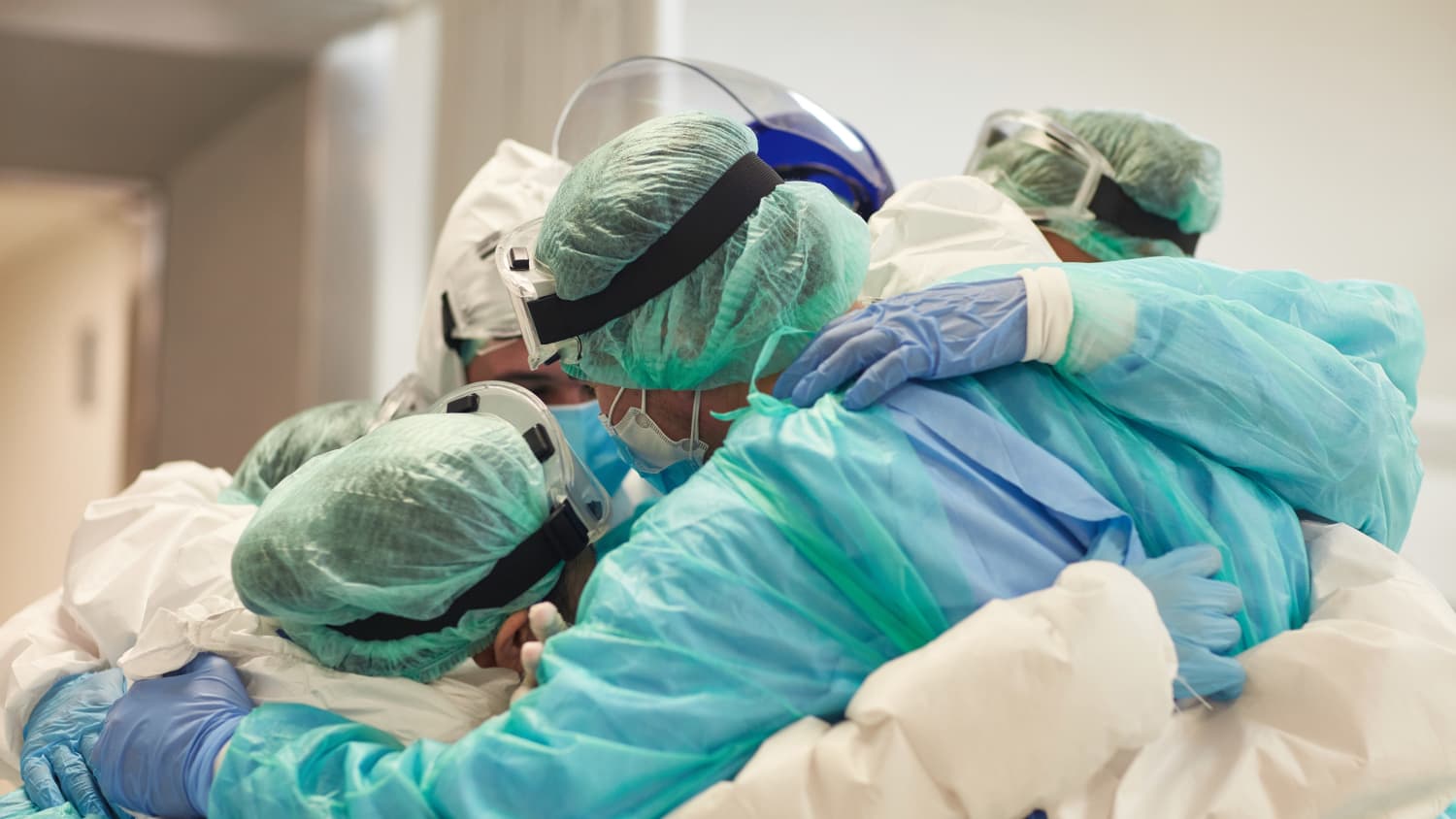 doctors and nurses huddled together during the COVID-19 pandemic