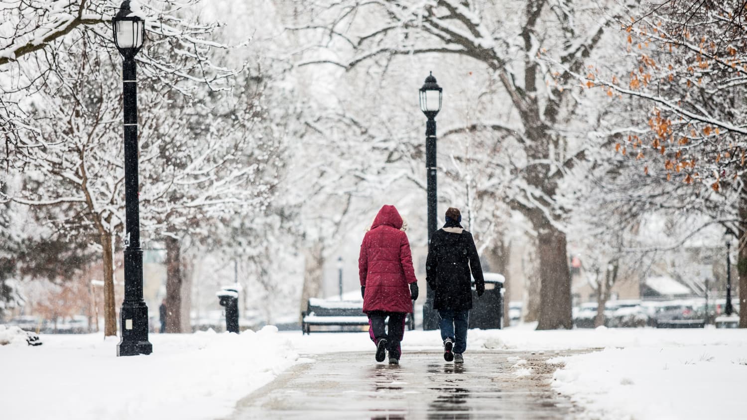 people walking on ice and snow illustrating how falls can be dangerous for your back