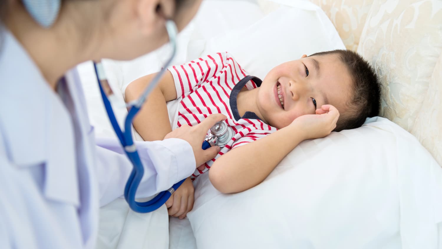 A doctor examines a child with a congenital heart defect.