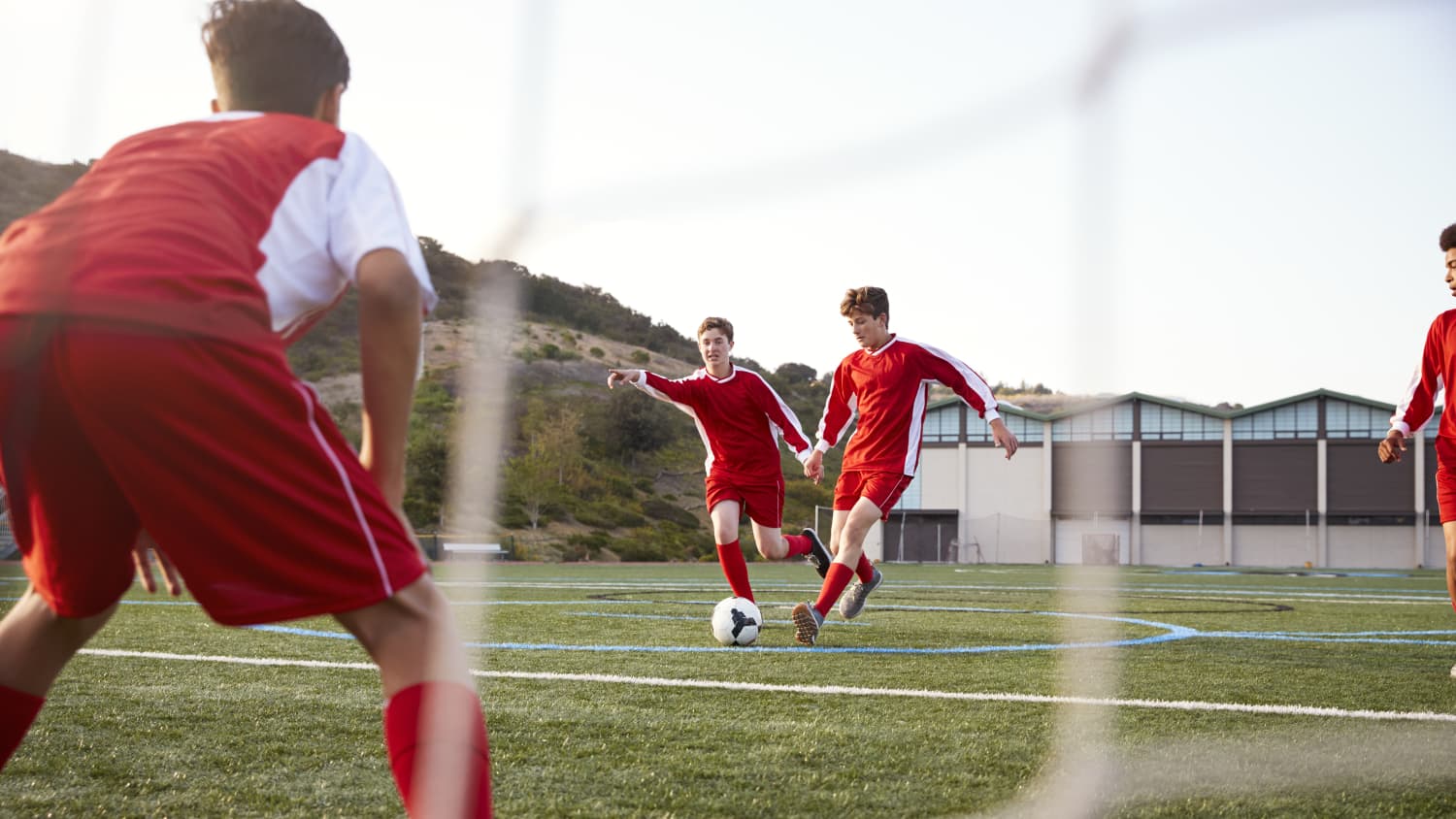 Male High School Students Playing In Soccer Team, highlighting the need for ECG testing for cardiac conditions