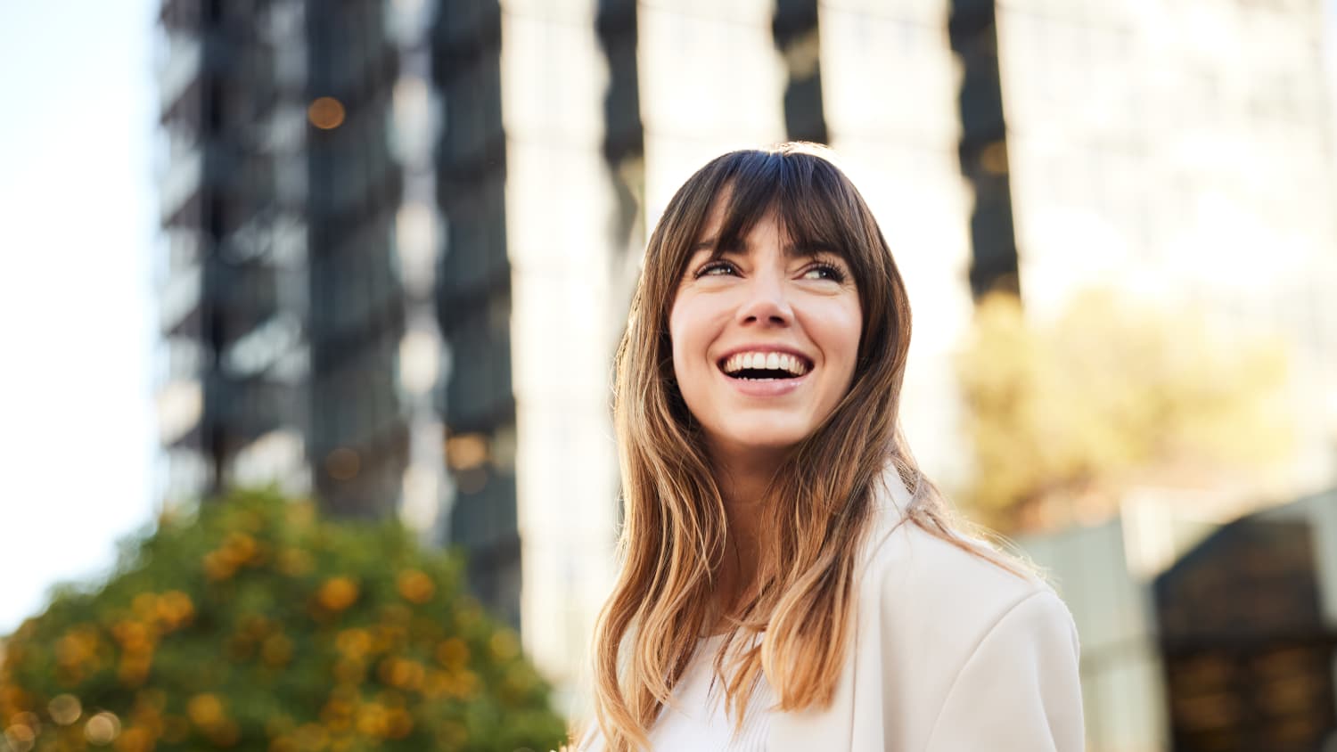 young woman smiling after receiving interventional psychiatry treatments