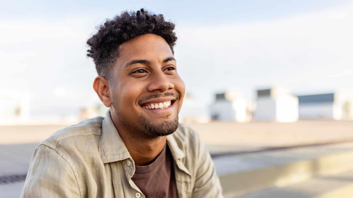 a man with Hyperparathyroidism smiles outdoors