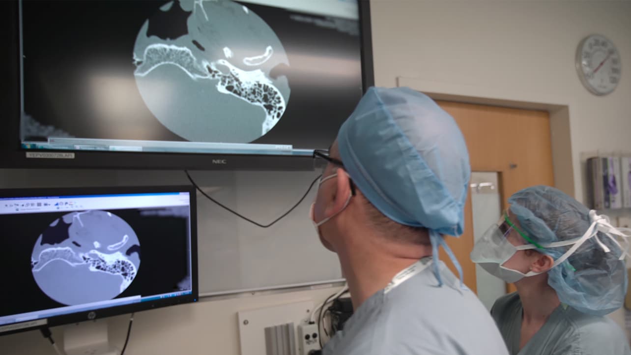 Doctors examine imagery of a patient's cochlea.