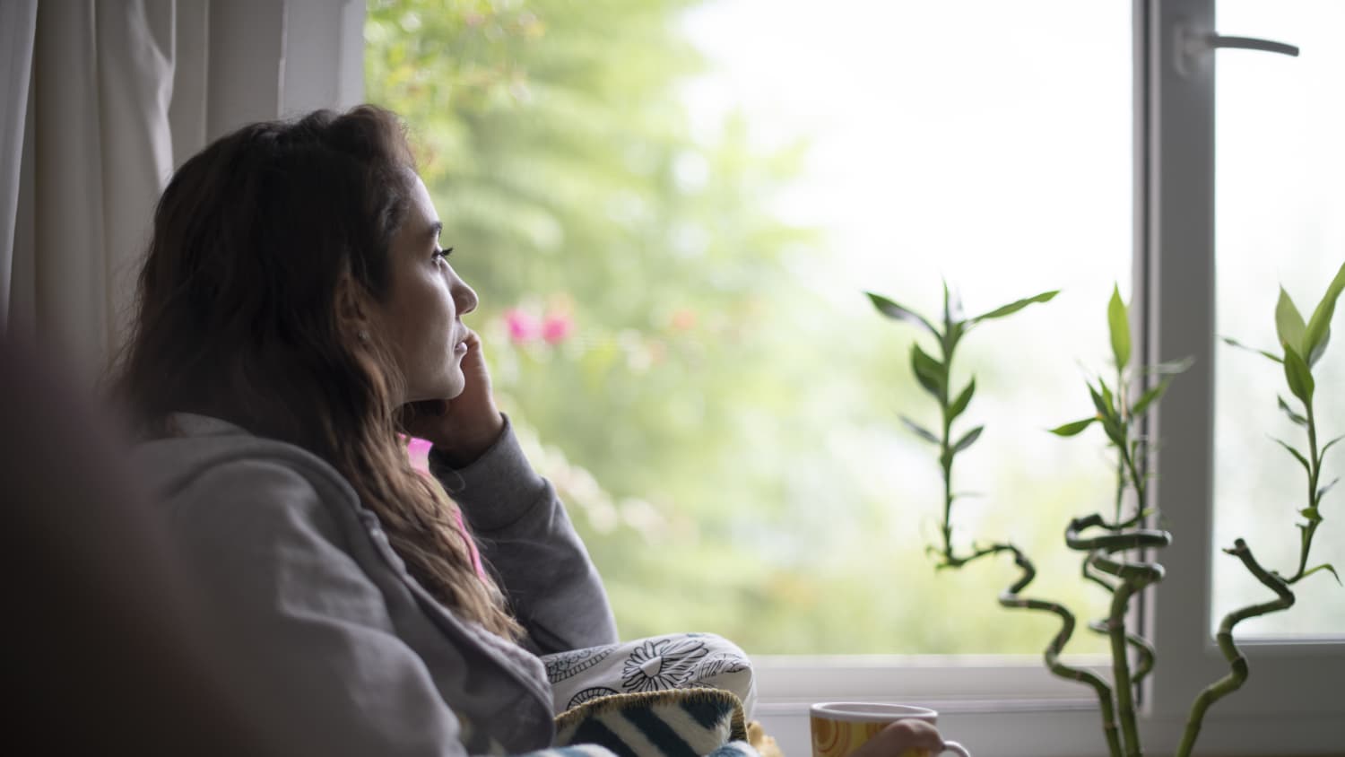 woman looking out window