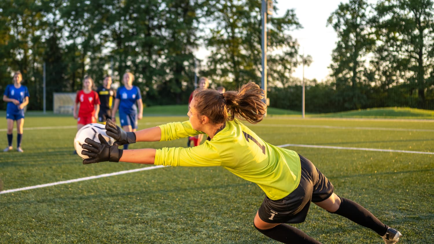young girl goalie blocking shot avoiding injuries treated at Female Athlete+ Program