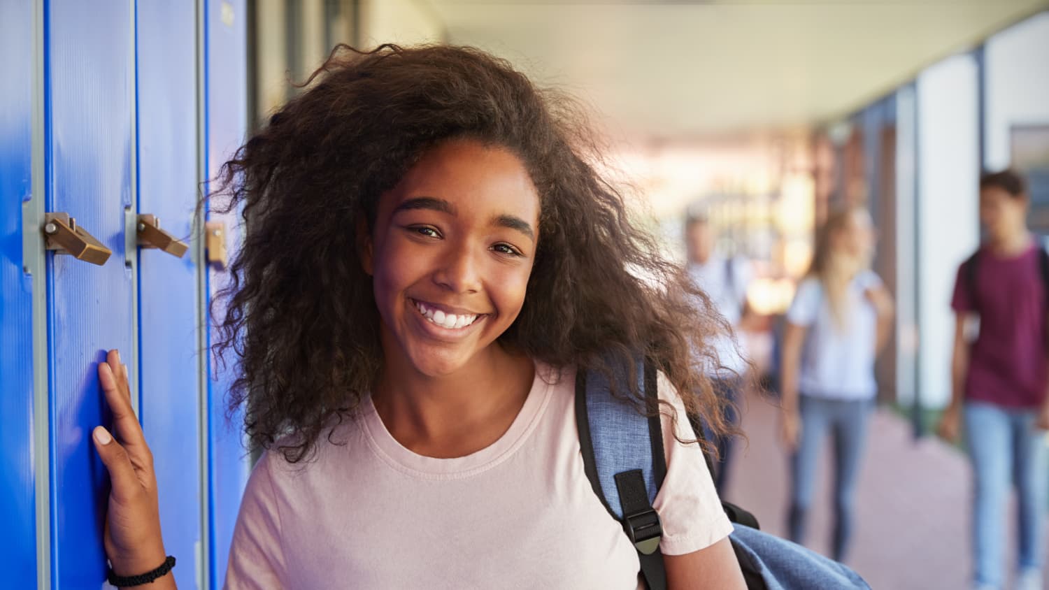 teenager smiling, possibly after pediatric cancer surgery