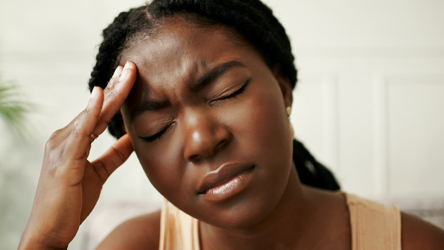 woman putting hand on her head to relieve cluster headache pain