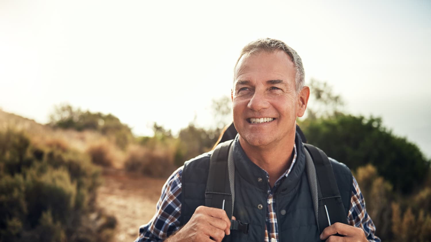 man smiling while hiking