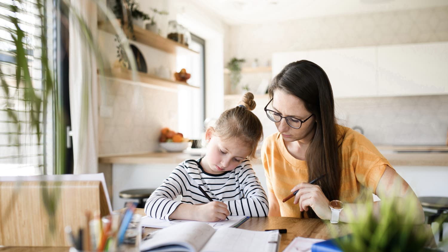 mother helping daughter with remote learning, using principles of social and emotional learning