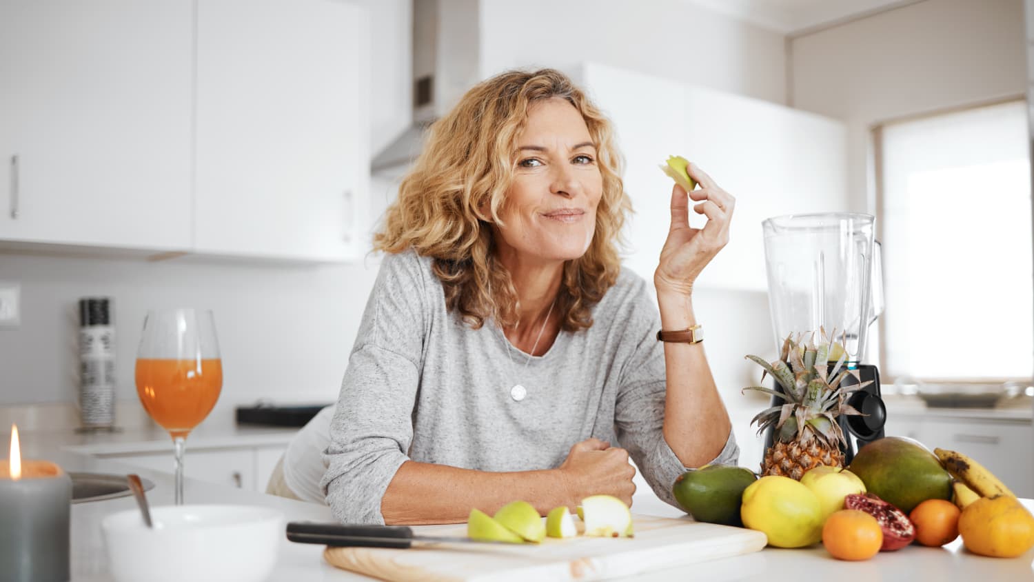 woman eating in her kitchen after treatment for achalasia