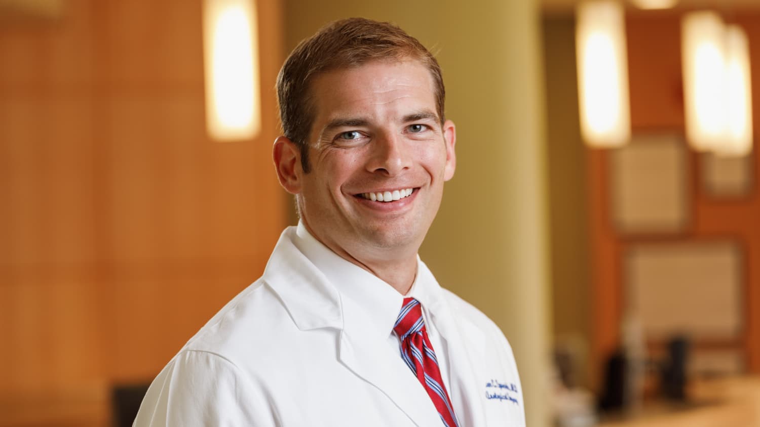 Horizontal portrait of Dr. Sprenkle in a white coat.