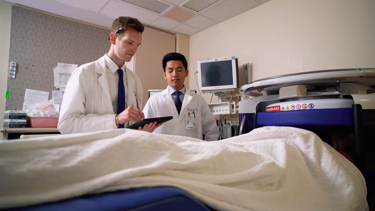 Doctors examine imaging from a portable MRI.