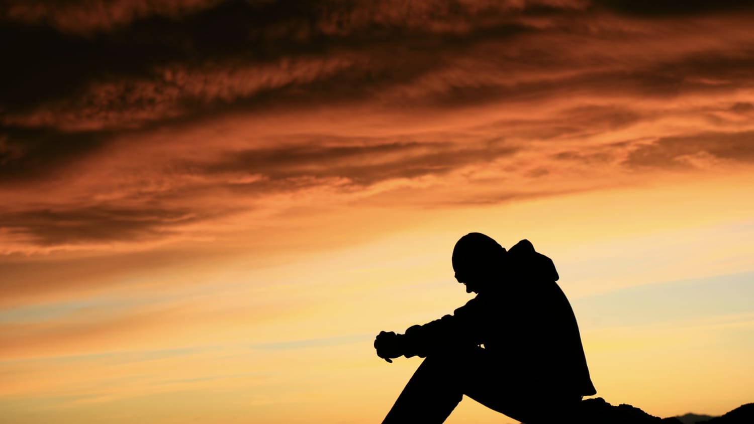 Silhouette of a young man, possibly thinking about his substance use disorder in a time of COVID-19