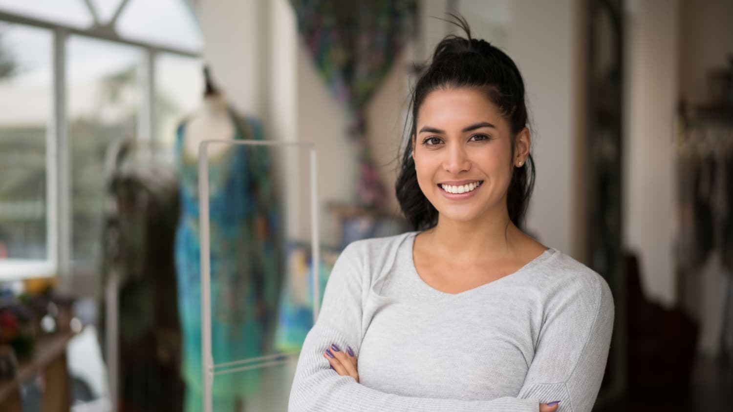 A young woman who may have survived cervical cancer stands smiling.