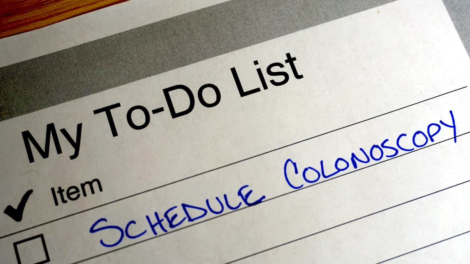 planner with note about scheduling a colonoscopy to remove colon polyps