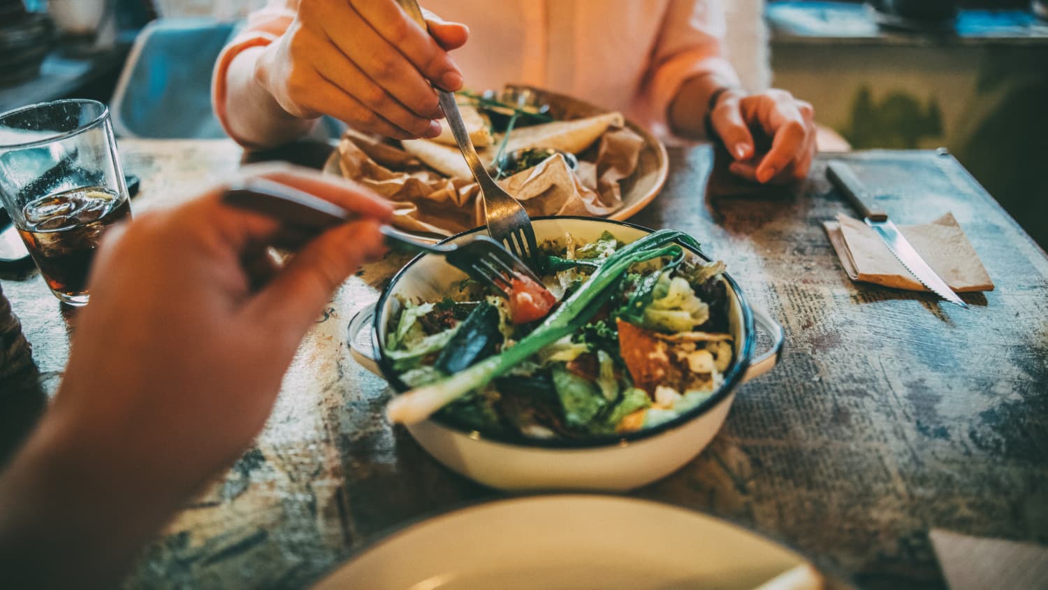 man and woman sharing food, highlighting the importance of anti-obesity medications in the treatment of obesity