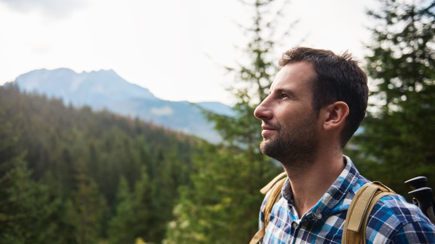 Male hiker admiring the view high up in the hills.