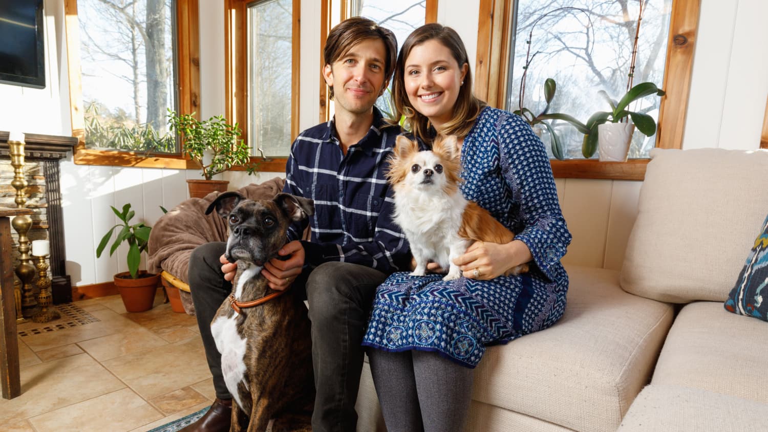 Marcus and Laura Gordon with their two dogs on the couch