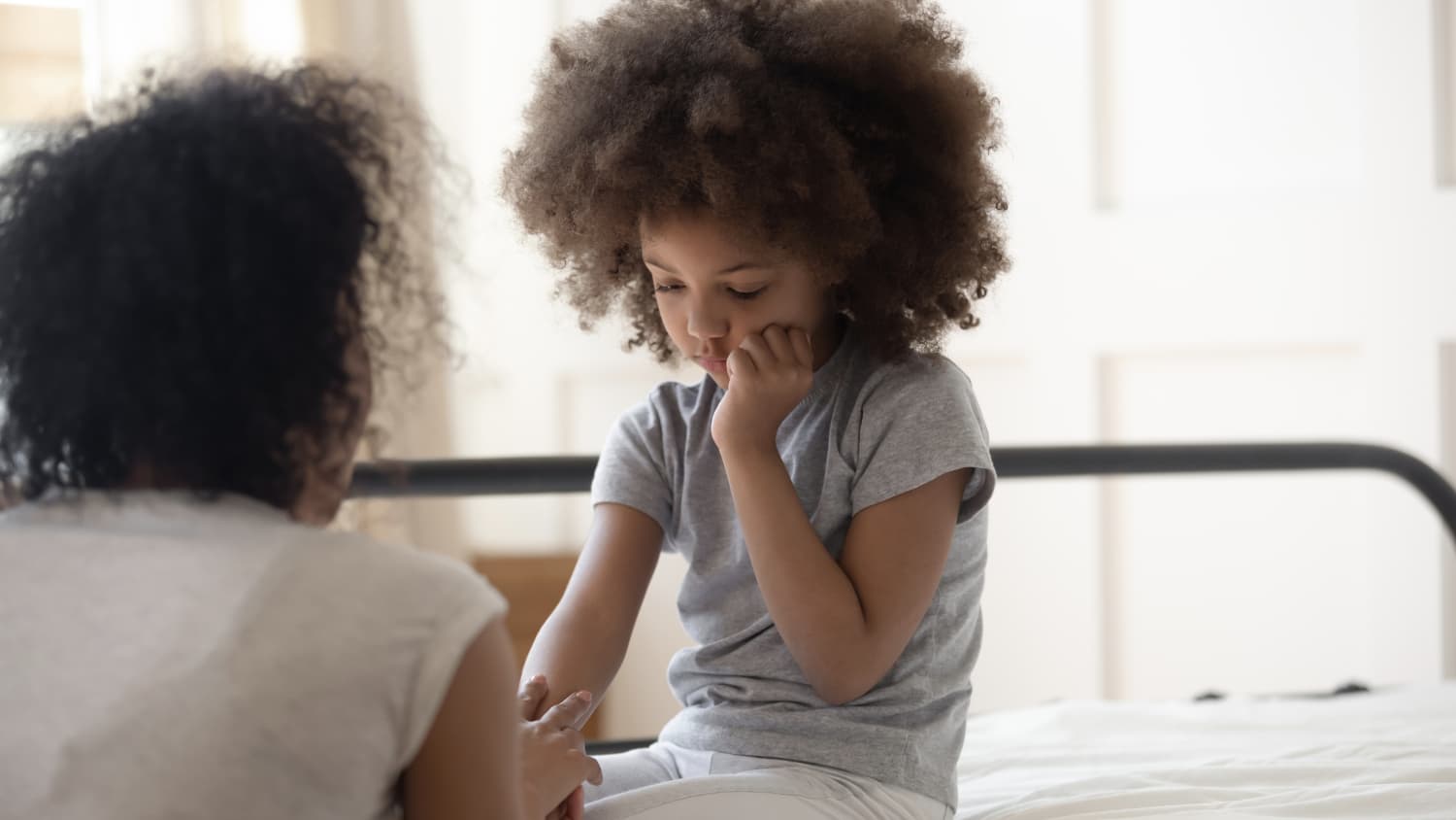 parent talking to child, possibly about the difficulties adjusting to life amid the COVID-19 pandemic