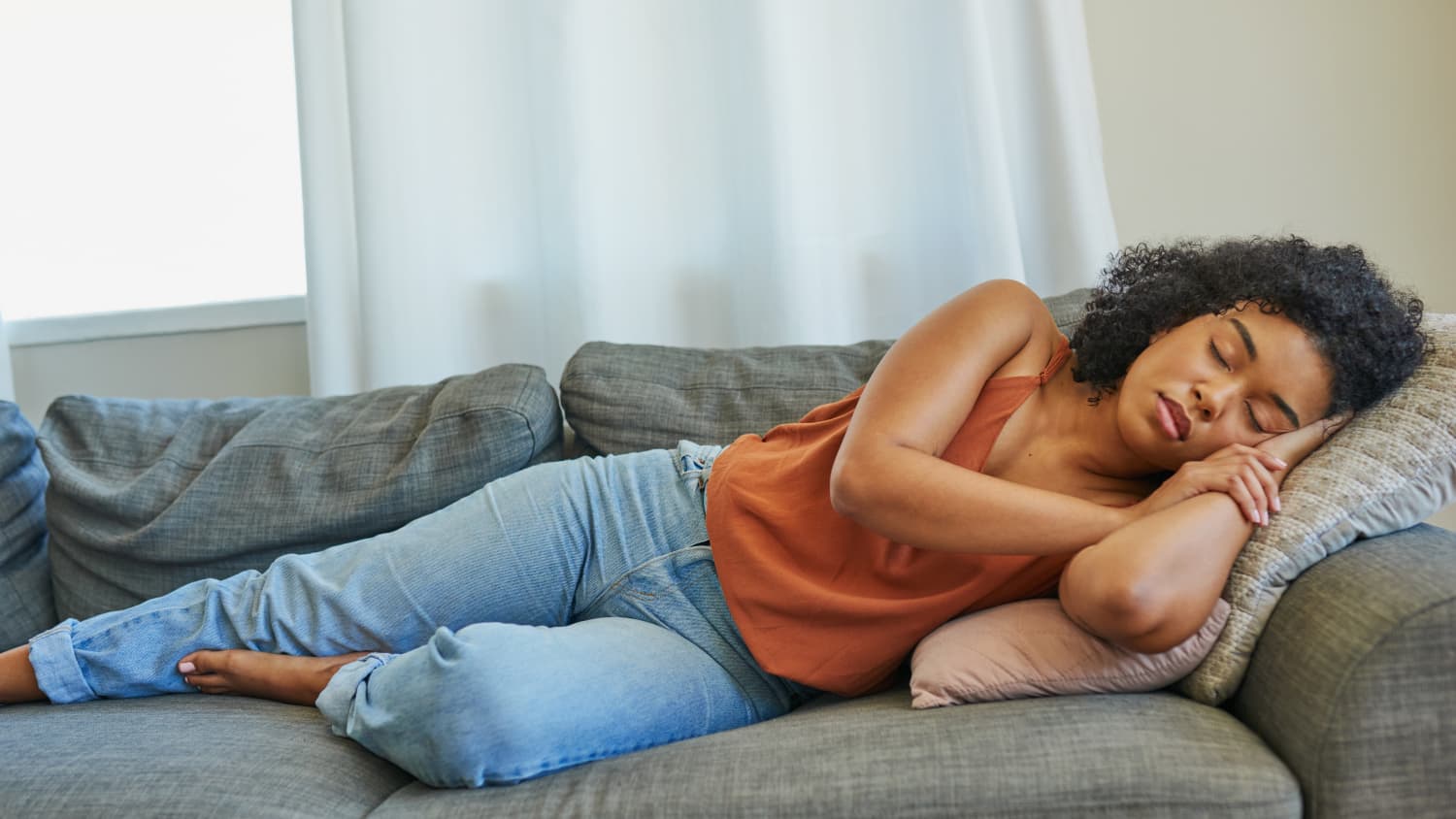 Black woman napping on a couch