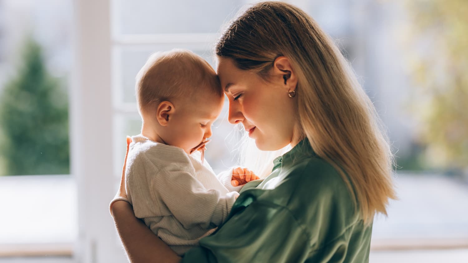 mother holds baby with Coarctation of the Aorta