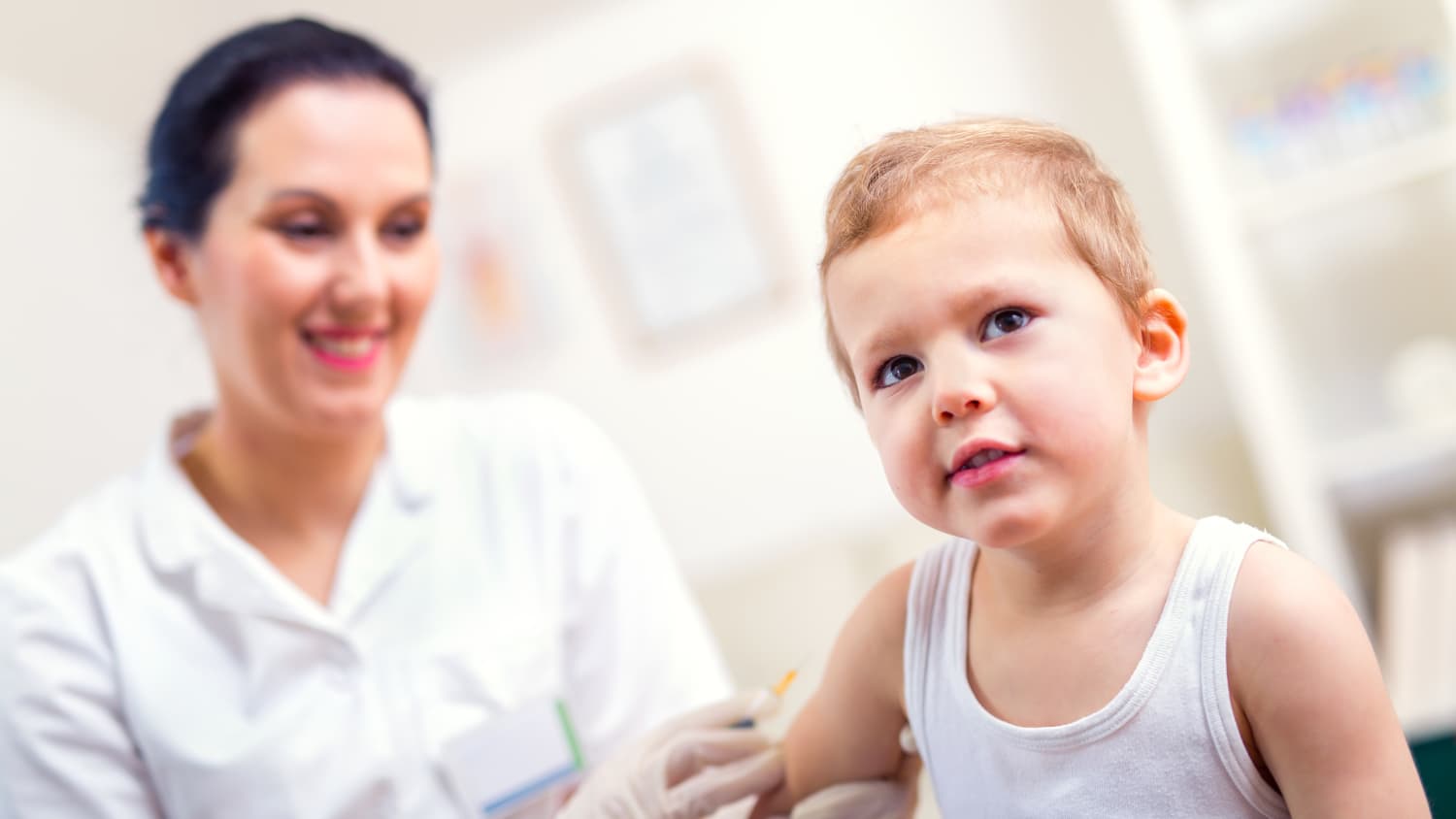 A boy receives his vaccination for measles