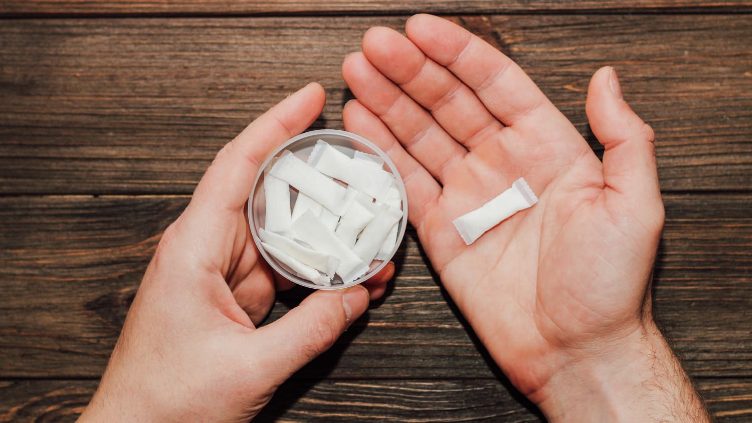 closeup of hands holding nicotine pouches