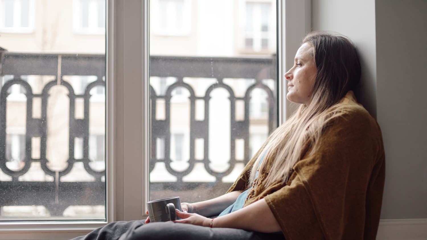 a woman with social anxiety disorder staring out a window