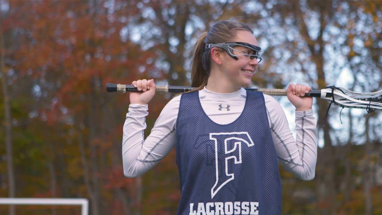 A lacrosse player holding her lacrosse stick.