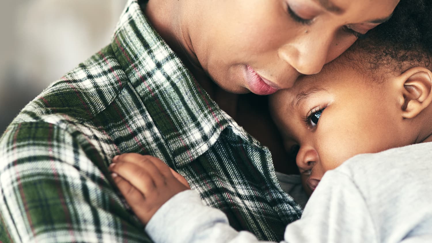 A parent holds a small child who may need a pediatric liver transplant