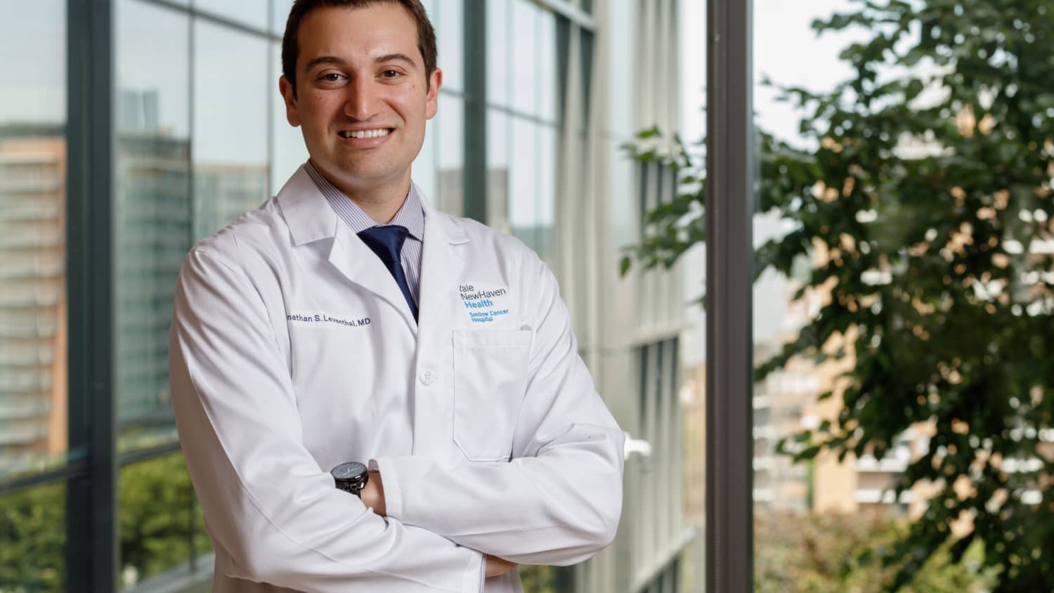 Dr. Leventhal stands in the hallway with his arms crossed.