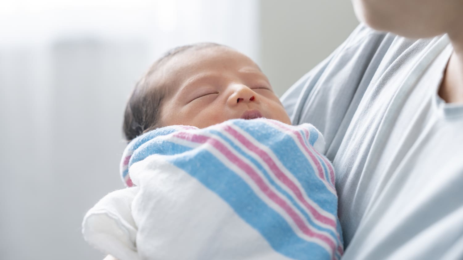 newborn baby with mother after fetal surgery