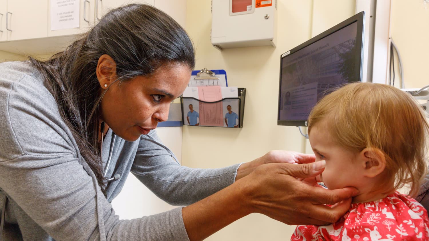 Dr. Cameron examines her young patient for signs of a congestion.