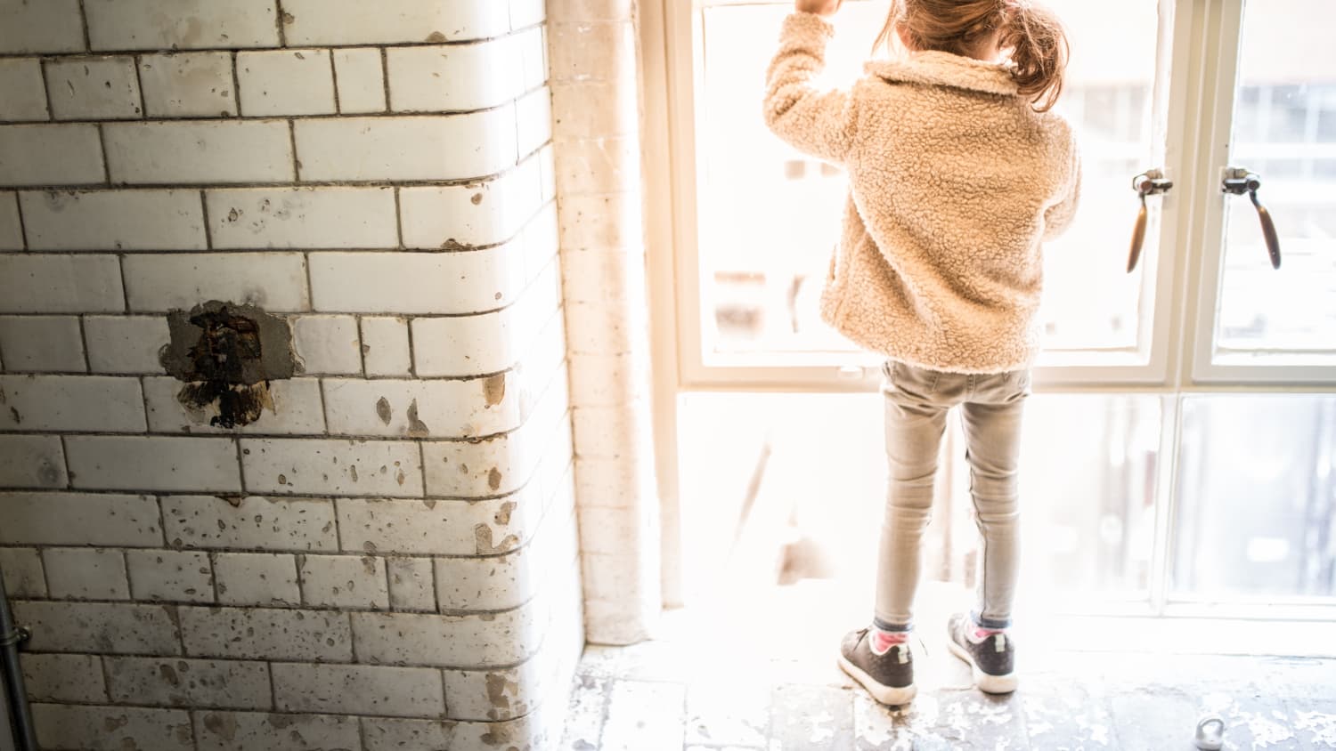 girl playing near a window, which may contain lead