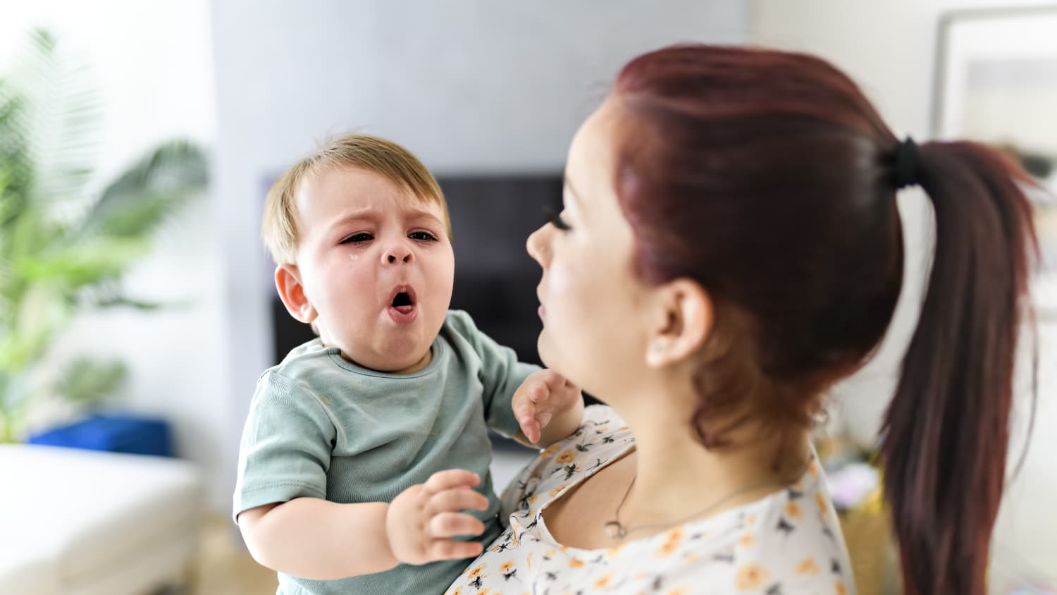 mom holding a baby with whooping cough (pertussis)