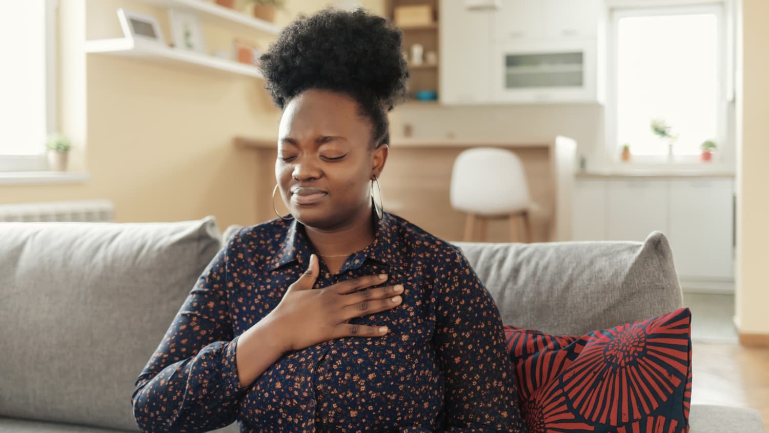 woman experiencing GERD (Gastroesophageal Reflux Disease)