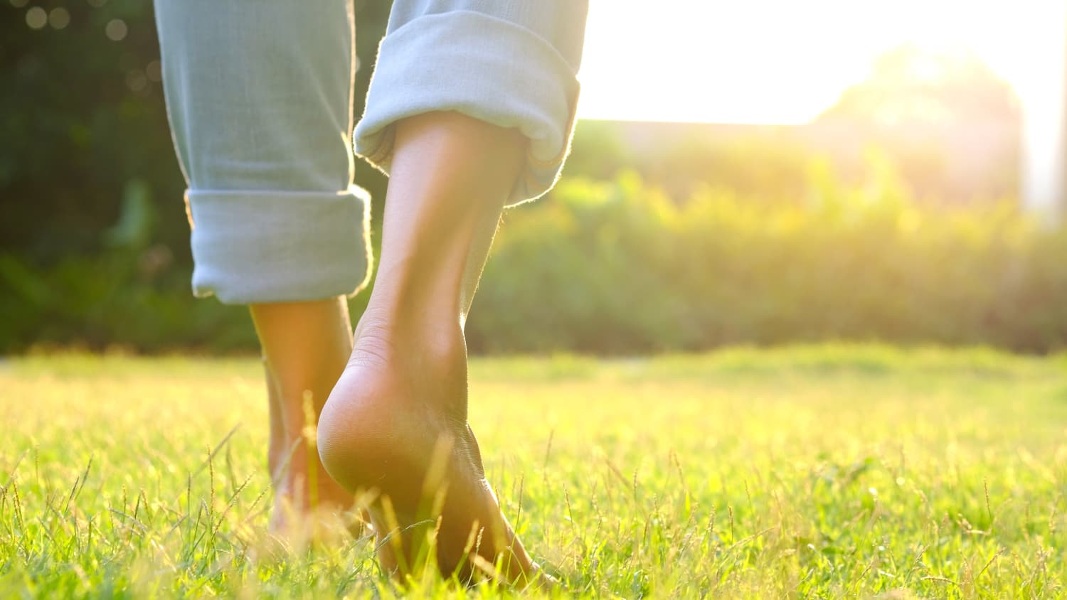 woman walking in grass after recovering from COVID-19