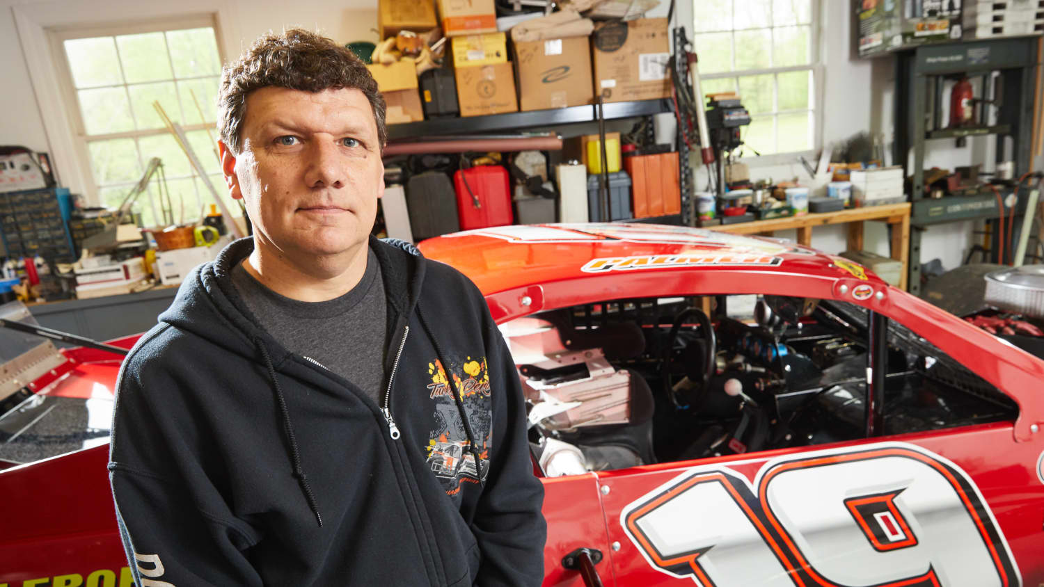 Robert Palmer with his race car, after recovering from surgery for an aortic aneurysm.