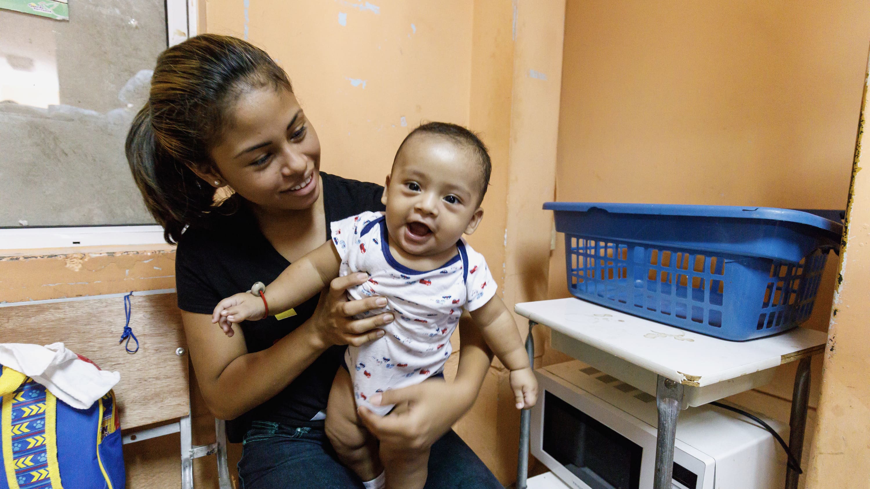 Jenifer, a young mom, holds her cute baby, Matias, before surgery.