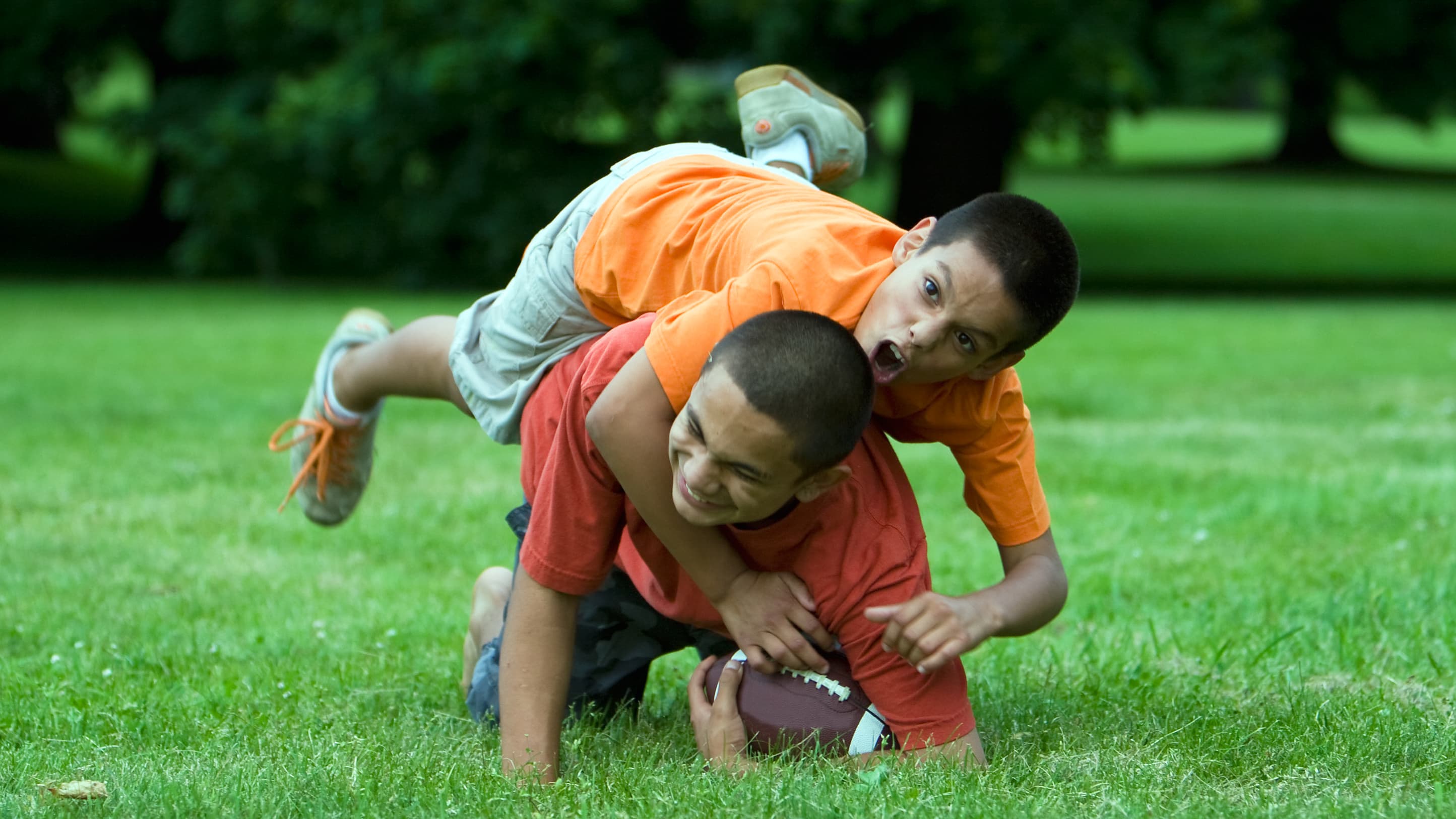 two kids playing football
