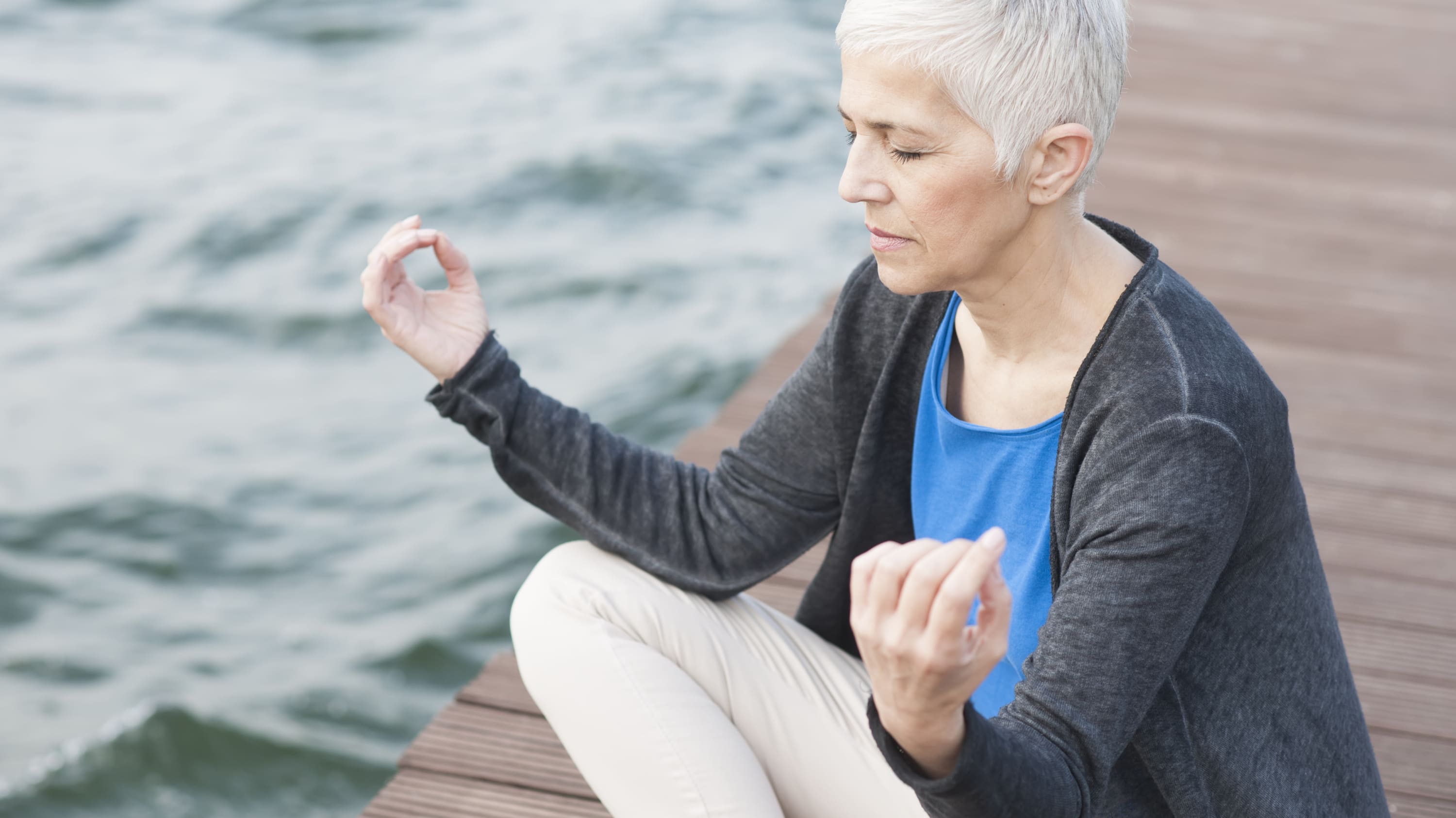 A woman with chronic pain practices yoga.