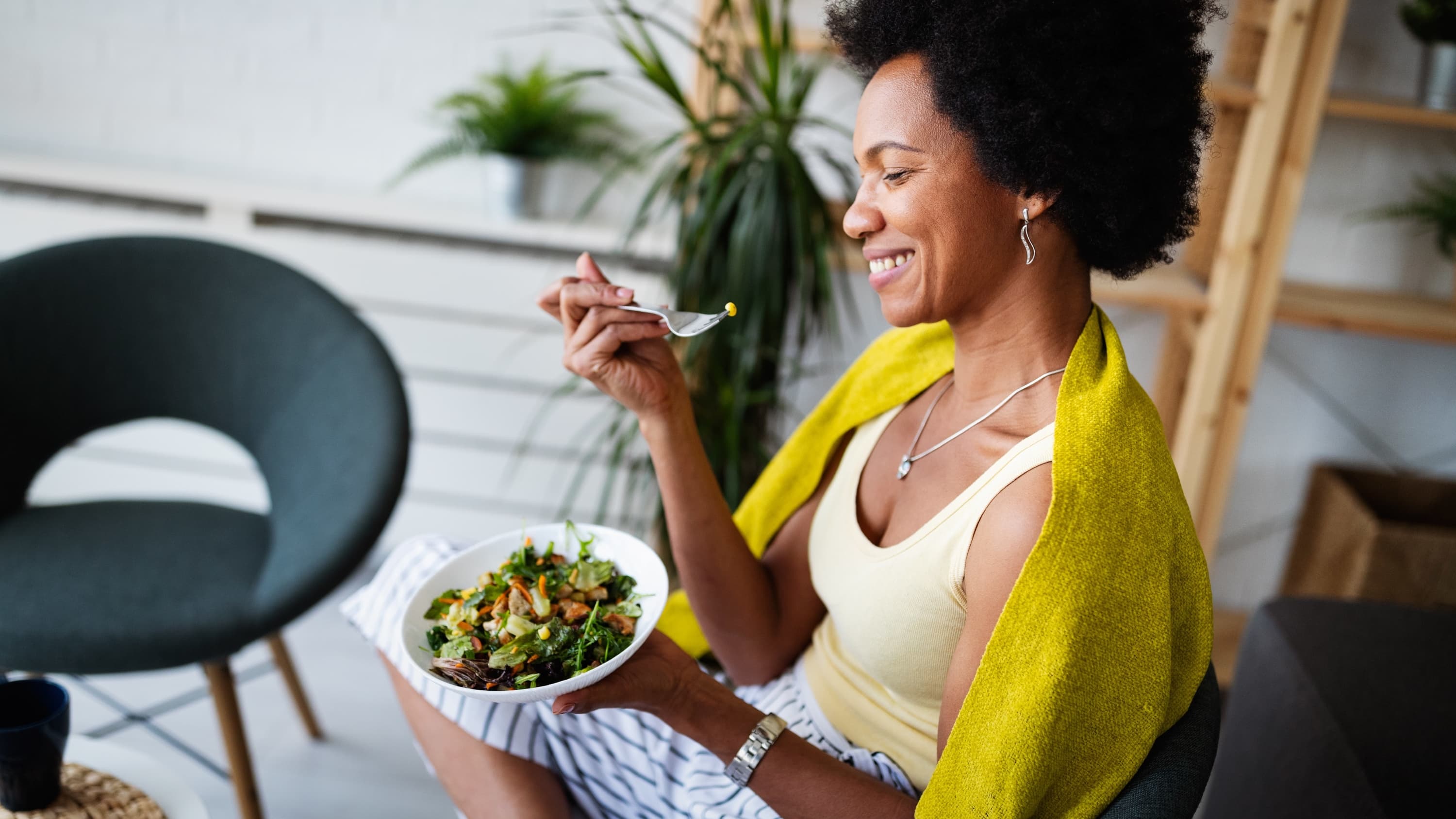 woman eating a salad after receiving POEM treatment for achalasia