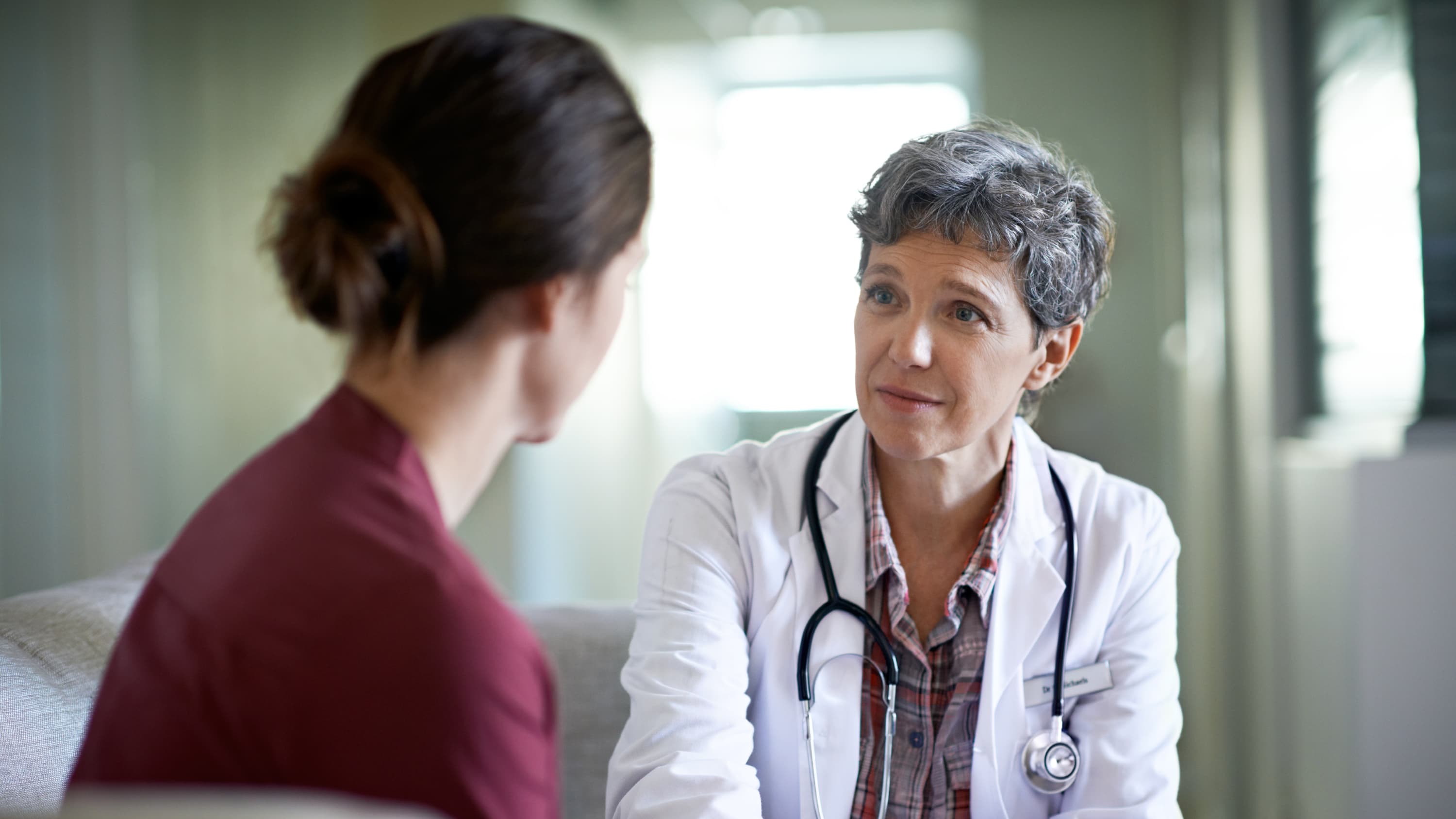 a doctor possibly discussing radiation therapy for pancreatic cancer with a female patient.